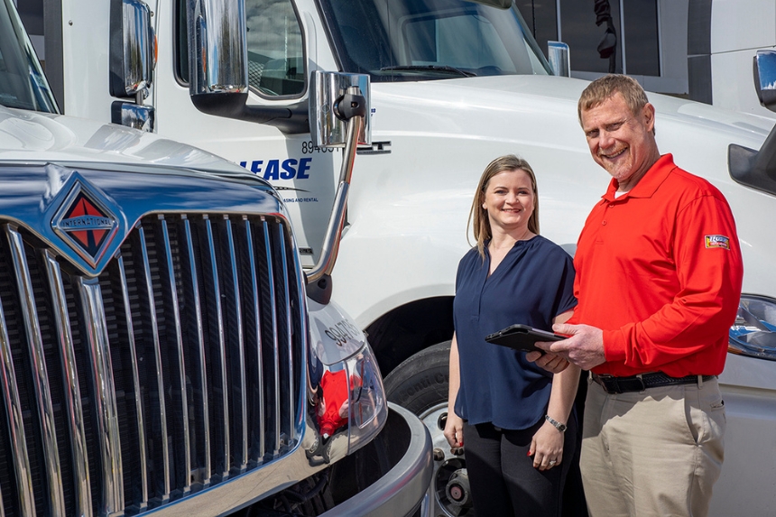 Rush Truck Leasing employee with customer standing next to truck